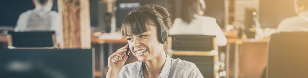 Woman talking on her headset in an office environment